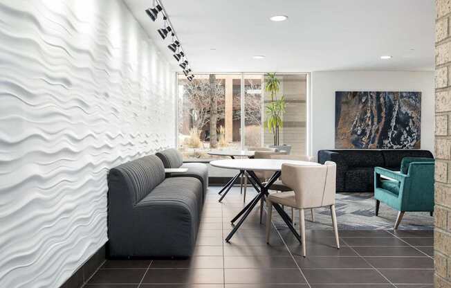 a living room with couches and a table and chairs