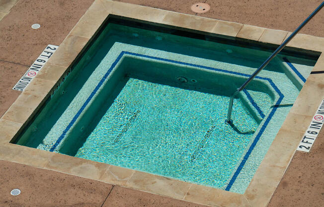 a hot tub with a ladder in the middle of it