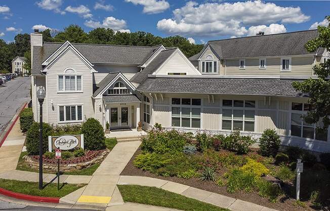a large white house with a garden in front of it