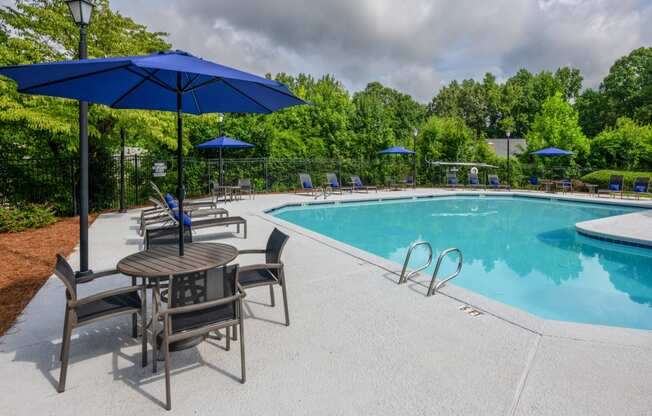 our apartments have a swimming pool with chairs and umbrellas