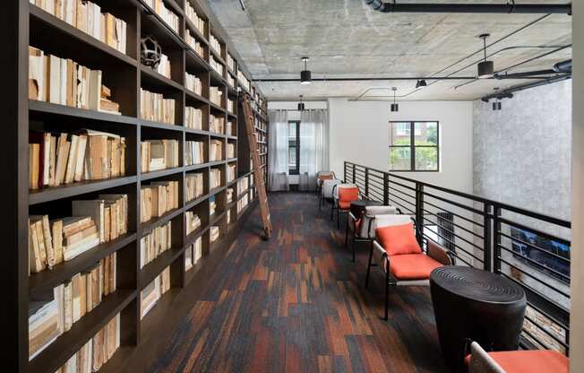 a library with a row of chairs and bookshelves