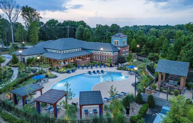 an aerial view of a resort with a large swimming pool