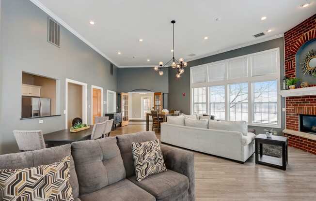 a living room with couches and chairs and a fireplace