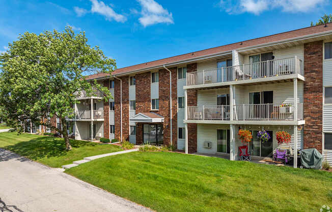Apartment building with a tree in front of it.