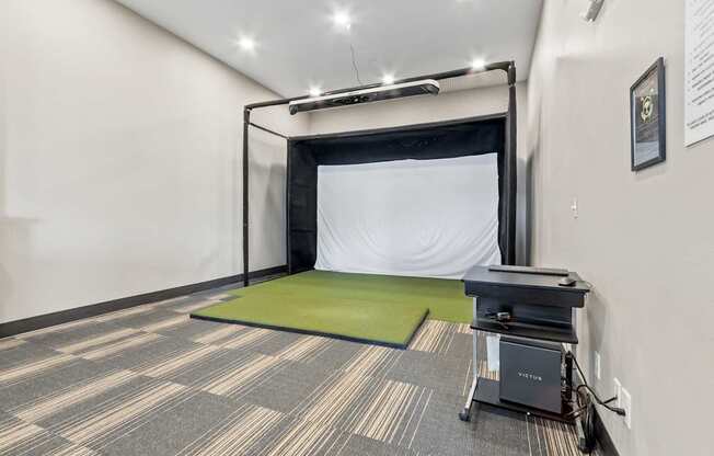 A room with a green mattress and a black table.