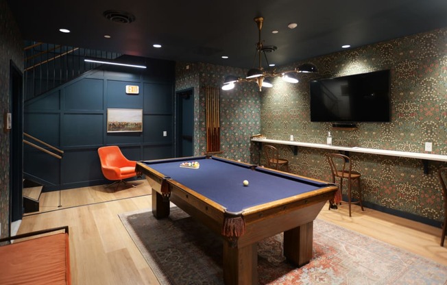 a game room with a pool table and a tv at The Commonwealth Building, Pittsburgh, 15222