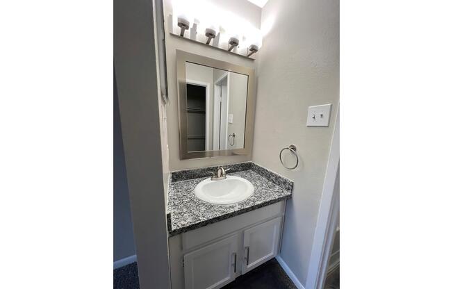 a kitchen with a sink and a mirror