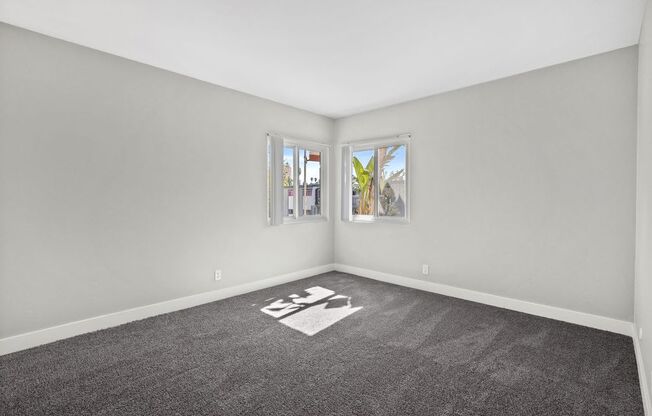 wall to wall carpet, stylish decor, and white walls at The Reserve at Warner Center, Woodland Hills, California