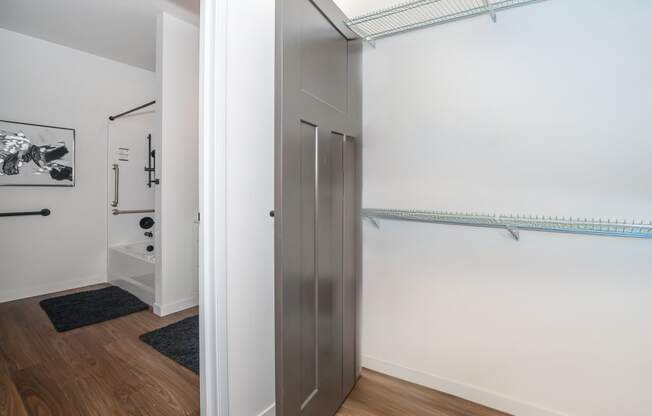 a closet in a room with white walls and wood floors at The Crossings at Windsong, Arizona, 86314