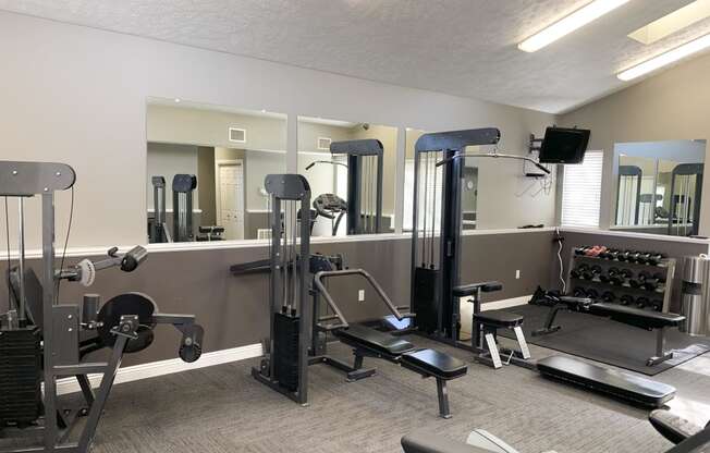 24 hour fitness center with strength training equipment and machines at Pine Lake Heights Apartments in Lincoln Nebraska