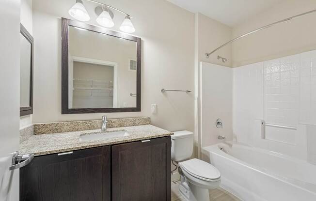 A bathroom with a sink, toilet, and bathtub.