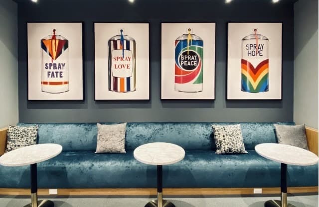 Four paintings of spray cans with different words written on them.