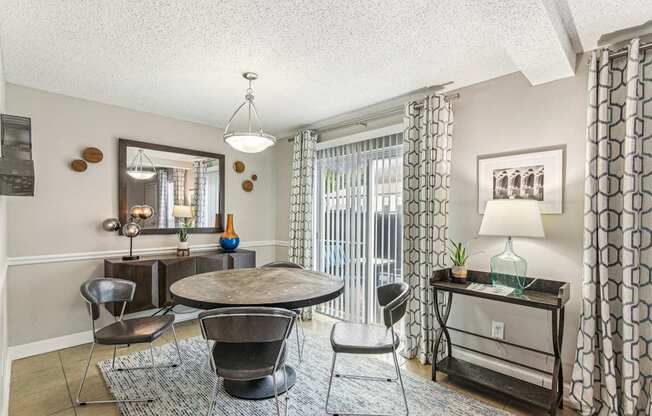 A living room with a round table and chairs.