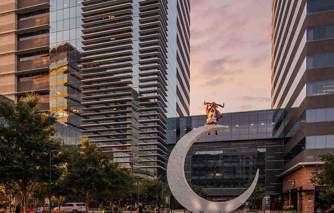 A fountain in the foreground with a large building in the background.