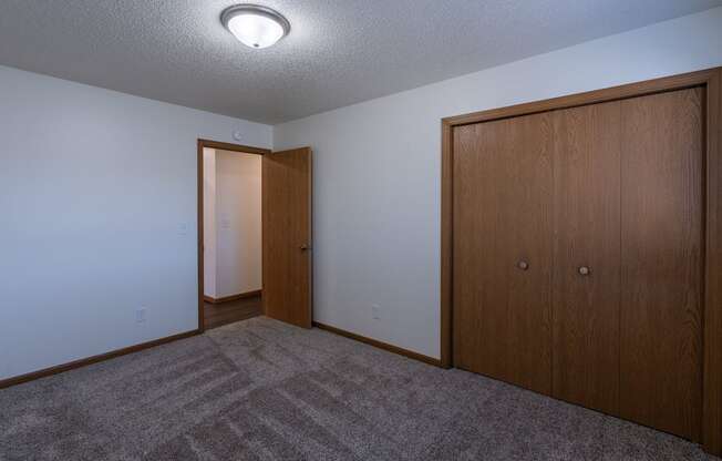 a bedroom with a closet. Fargo, ND Westwood Apartments