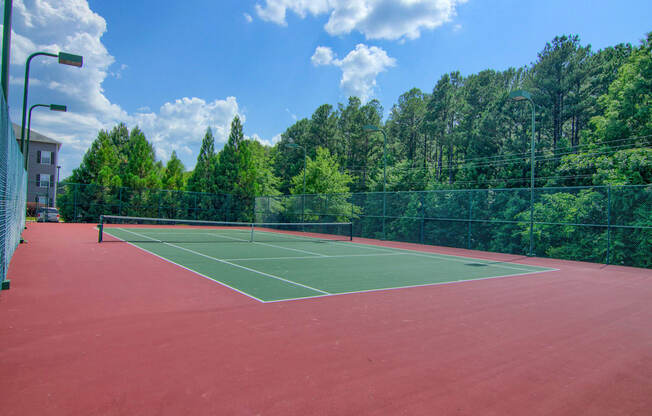 Lancaster Place Apartments in Calera Alabama photo of a tennis court with trees in the background