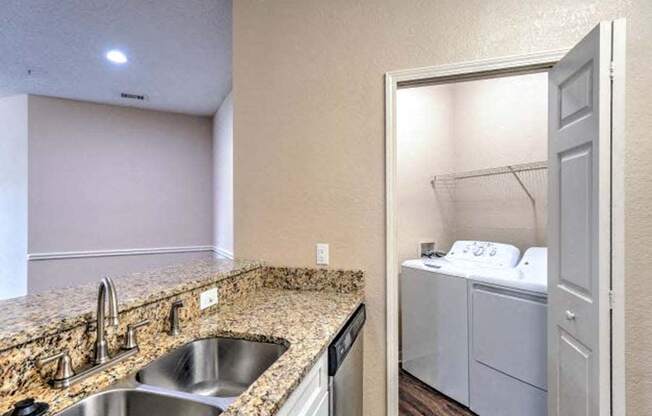 a kitchen with a sink and a washer and dryer  at Ocean Park, Florida