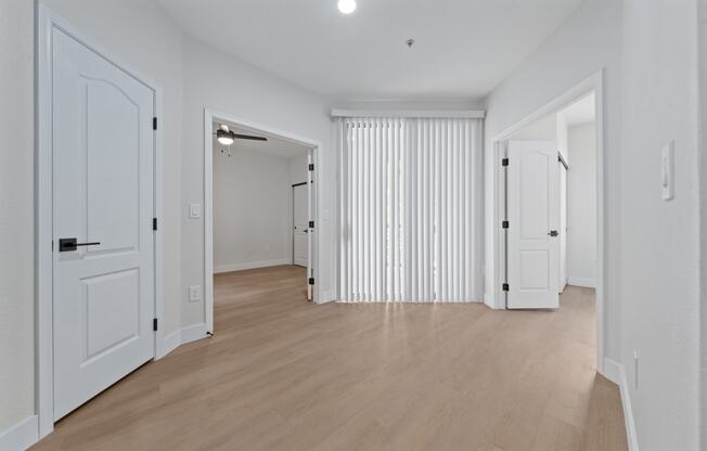 a bedroom with hardwood floors and white walls