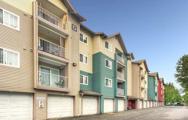 Apartment building with balconies and garages.