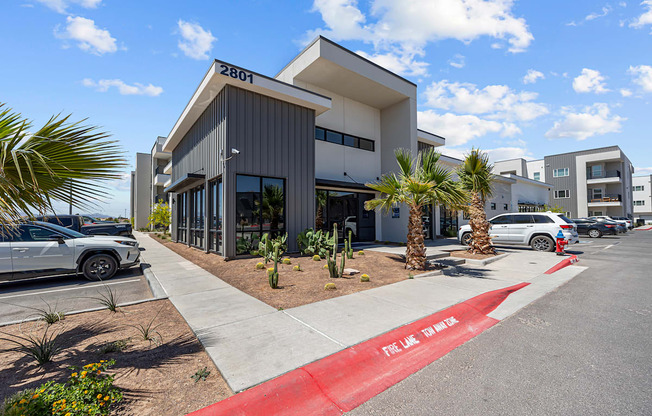 the exterior of a building with palm trees in front of it