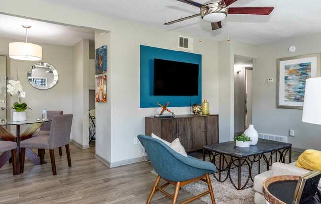 a living room with a tv and a table and chairs