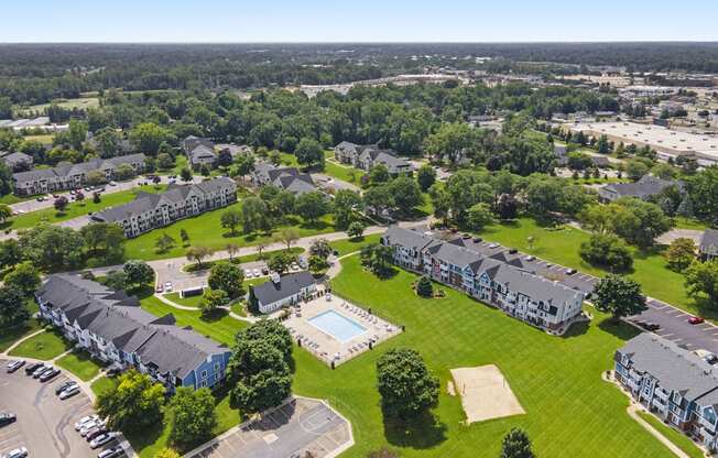 an aerial view of a pool with sundeck at Newport Village Apartments, Portage, MI