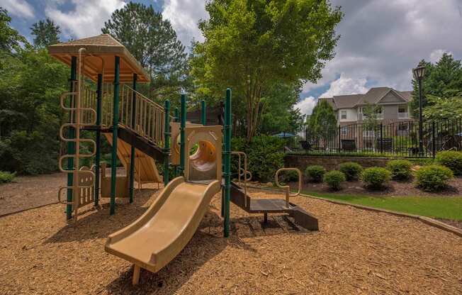 a playground with a slide and a swing set
