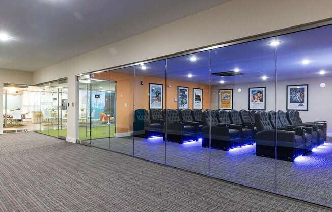 a large lobby with blue chairs and glass walls