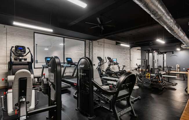 a gym with treadmills and other exercise equipment