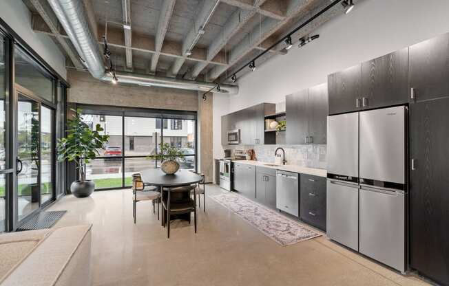 a kitchen with stainless steel appliances and a dining table