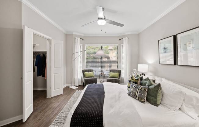 a bedroom with a large bed and a ceiling fan