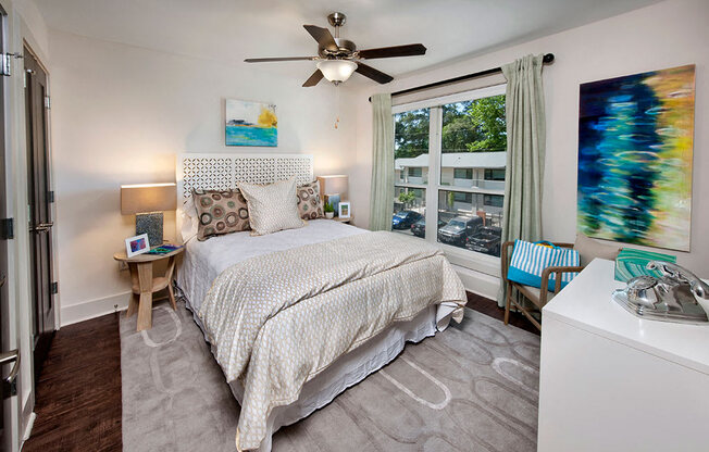 a bedroom with a bed and windows