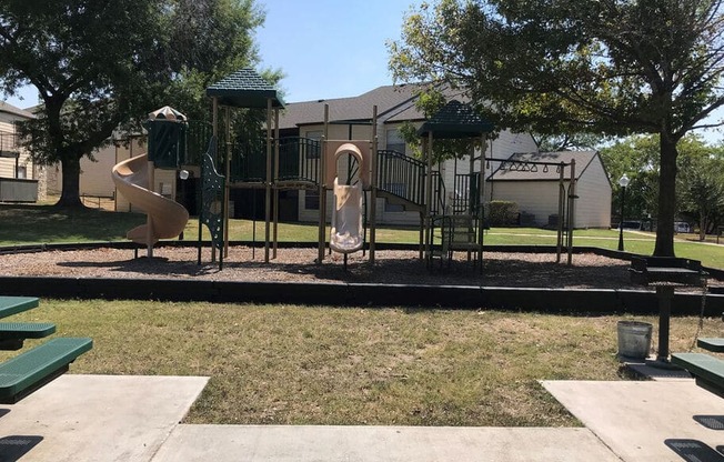 A playground with a slide, swings, and a climbing structure.
