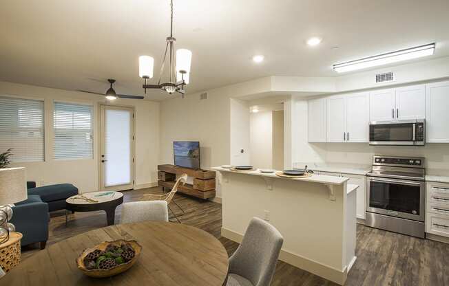 a kitchen and living room with a table and chairs