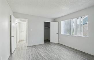 an empty living room with white walls and wood flooring