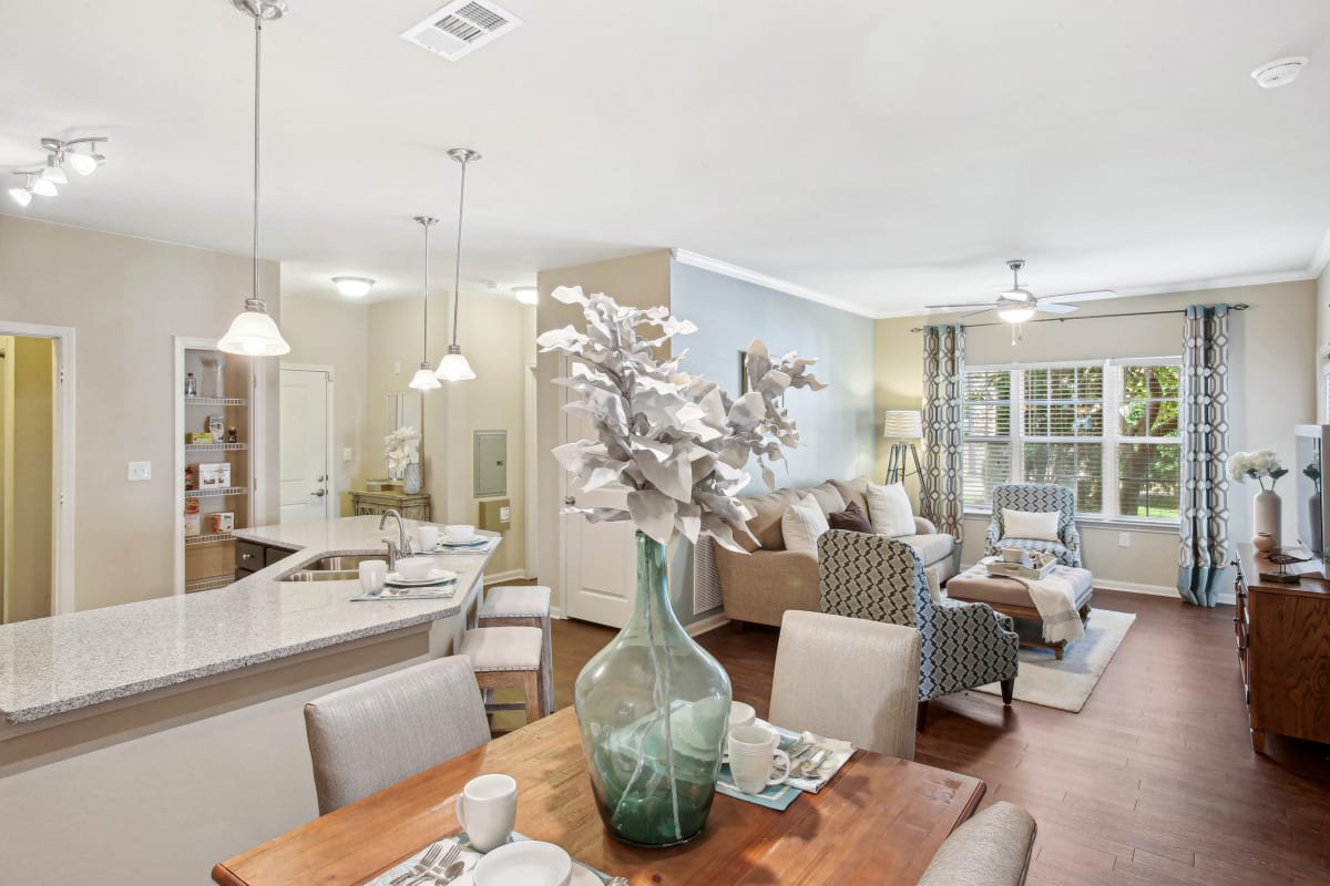a living room and dining room with a table and chairs