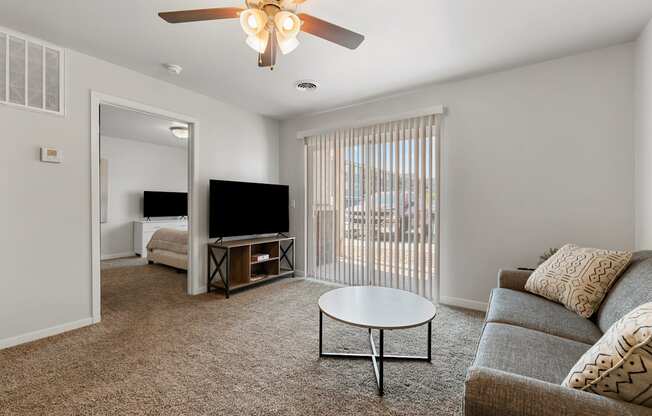 a living room with a couch and a coffee table and a tv