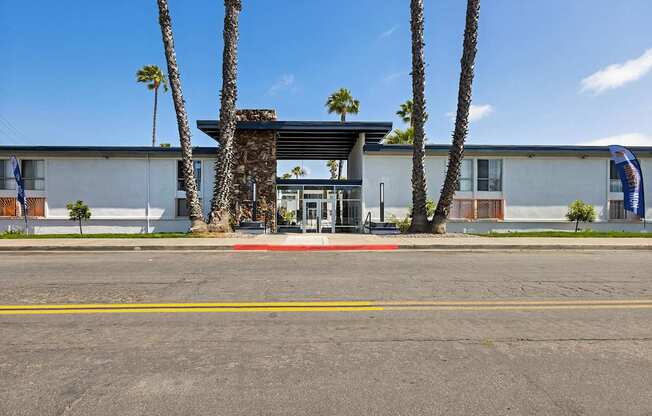 A building with a palm tree in front of it.