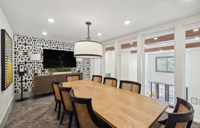 a dining room with a large wooden table and chairs