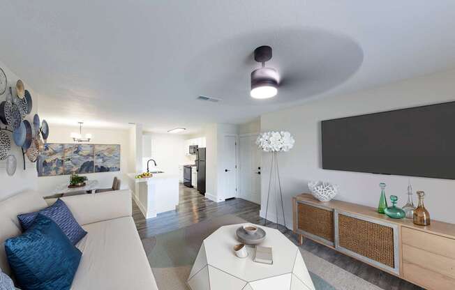 A modern living room with a white sofa and a large painting on the wall.