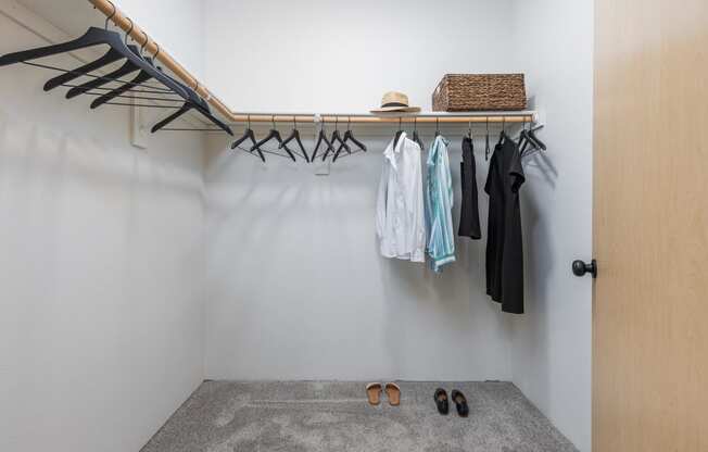 a walk in closet with a clothes rack and shoes on the floor  at Shoreline Village, Richland, WA, 99352