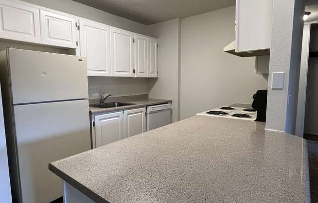 a kitchen with white cabinets and white appliances