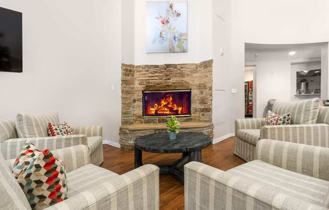 a seating are in front of a fireplace