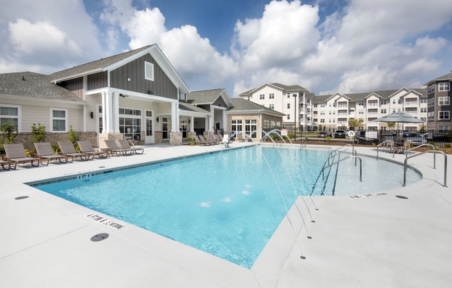 Sparkling swimming pool with large sundeck and lounge chairs at at the Station at Savannah Quarters in Pooler, GA