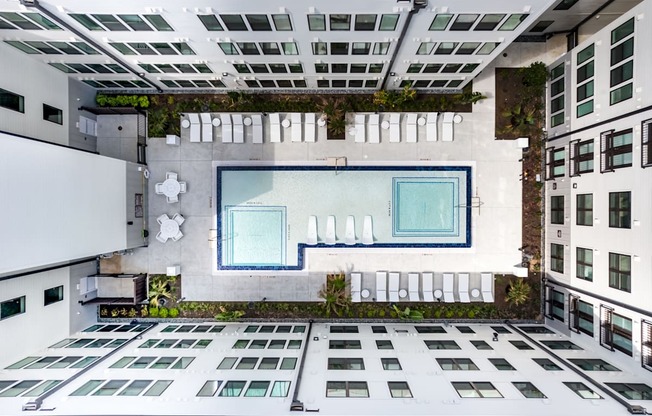 A modern building with a large glass window in the center.