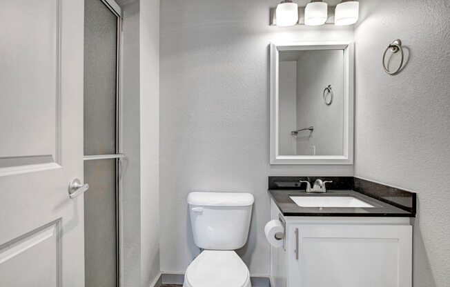 a bathroom with a toilet sink and shower