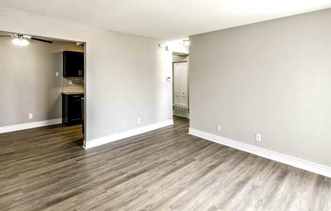 a bedroom with hardwood floors and grey walls