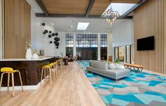 Lobby area with a couch and television at Presidio Palms Apartments, Arizona , 85701