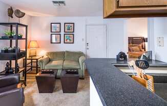 a living room and kitchen with a couch and coffee table