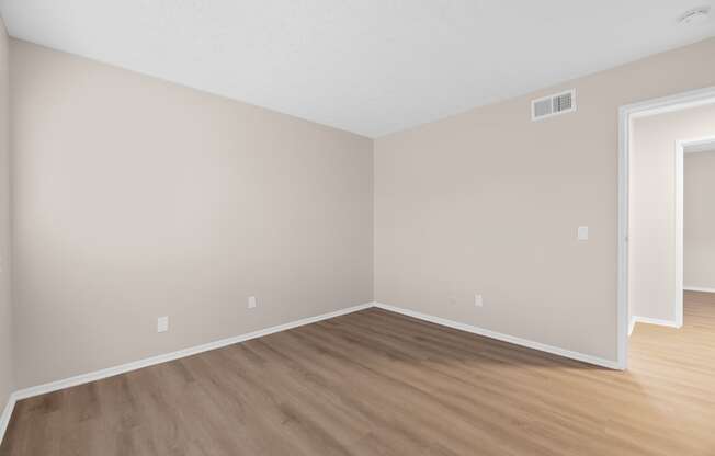 A room with wooden flooring and a white ceiling.